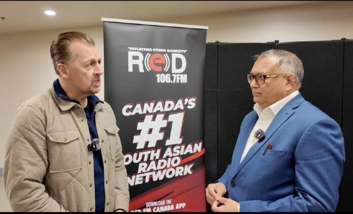 Minister Mike Ellis during a conversation with Rishi Nagar.